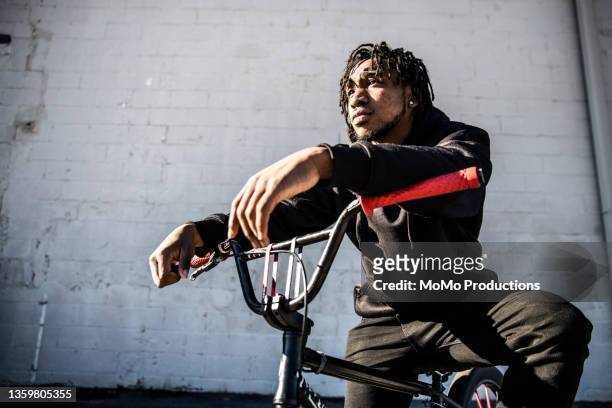 portrait of young male bmx rider in urban area - music inspired fashion stock pictures, royalty-free photos & images