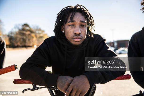 portrait of young male bmx riders in urban area - forward athlete stockfoto's en -beelden