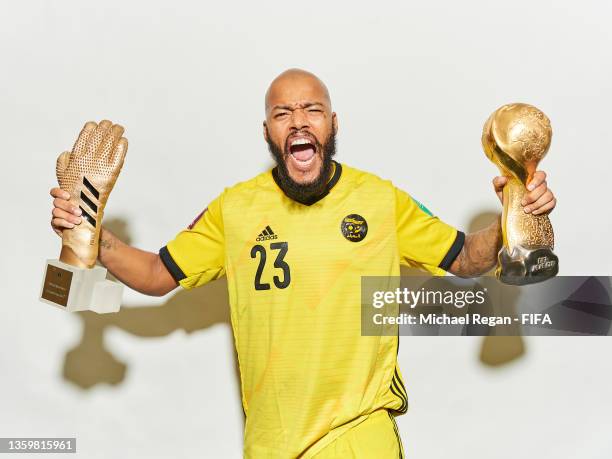 Rais Mbolhi of Algeria celebrates with the adidas Golden Glove award and the FIFA Arab Cup Winner's Trophy following the FIFA Arab Cup Qatar 2021...