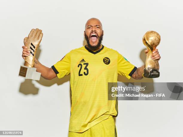 Rais Mbolhi of Algeria celebrates with the adidas Golden Glove award and the FIFA Arab Cup Winner's Trophy following the FIFA Arab Cup Qatar 2021...
