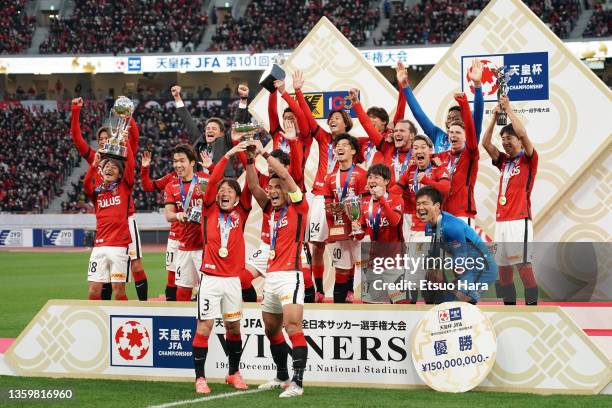 Players of Urawa Red Diamonds celebrate as captain Tomoaki Makino and Tomoya Ugajin lift the trophy after the 101st Emperor's Cup final between Urawa...