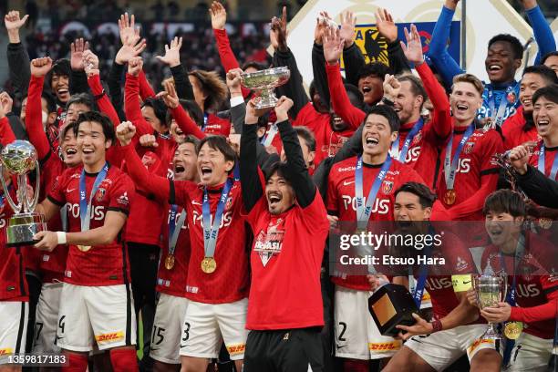 Players of Urawa Red Diamonds celebrate as Yuki Abe lifts the trophy after the 101st Emperor's Cup final between Urawa Red Diamonds and Oita Trinita...