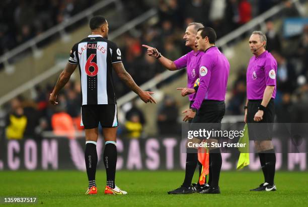 Jamaal Lascelles of Newcastle United interacts with referee Martin Atkinson at half time during the Premier League match between Newcastle United and...