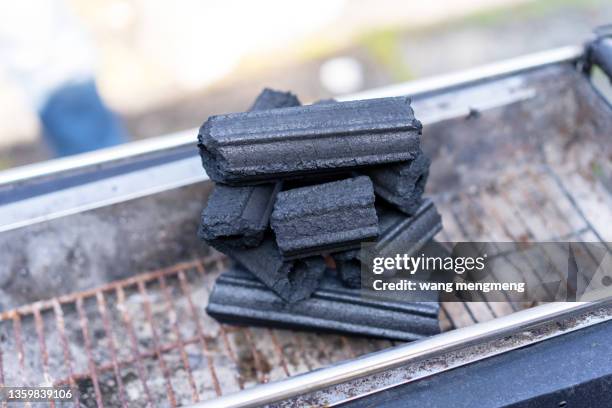 a charcoal fire for an outdoor barbecue - briketts stock-fotos und bilder