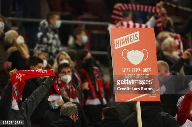 Covid-19 sign informing fans to wear a face mask inside the stadium is seen prior to the Bundesliga match between 1. FC Köln and VfB Stuttgart at...