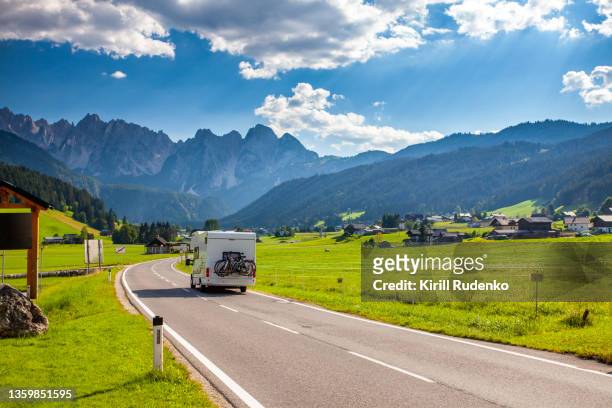 road in austrian alps - camping trailer stock pictures, royalty-free photos & images