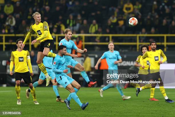 Erling Haaland of Borussia Dortmund rises above the defenders, heads the ball scoring his teams second goal of the game during the Bundesliga match...