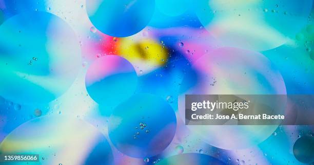 full frame of abstract background with a mixture of colored liquids in motion. - protozoo fotografías e imágenes de stock