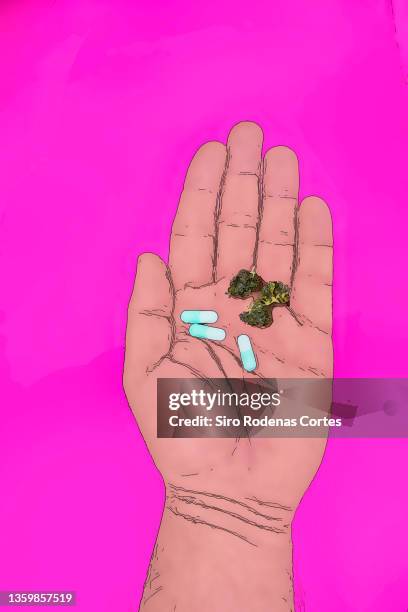 hand with pills and marijuana - stick plant part stockfoto's en -beelden
