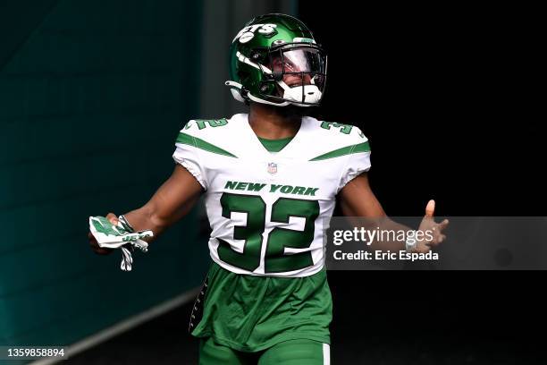 Michael Carter of the New York Jets jogs out of the players tunnel and takes the field for warm-up before the game against the Miami Dolphins at Hard...