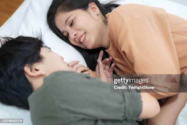 young lesbian love couple doing activities on the bed with happiness together, lgbtqia - asian lesbians kiss stock pictures, royalty-free photos & images