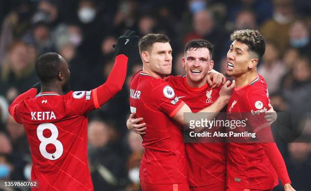 Andrew Robertson celebrates with teammates James Milner, Roberto Firmino and Naby Keita of Liverpool after scoring their team's second goal during...