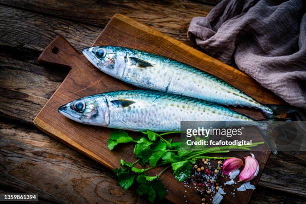 raw mackerel fish on a cutting board. top view - makreel stockfoto's en -beelden