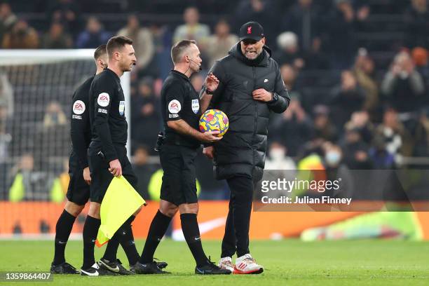 Juergen Klopp, Manager of Liverpool speaks to Referee Paul Tierney after the full time whistle during the Premier League match between Tottenham...