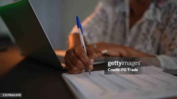 senior woman using laptop control spreadsheet - spreadsheet stock pictures, royalty-free photos & images