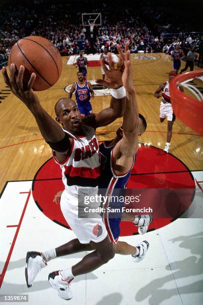 Clyde Drexler of the Portland Trailblazers drives to the basket for a layup against the New Jersey Nets in 1995 during the NBA game in Portland,...