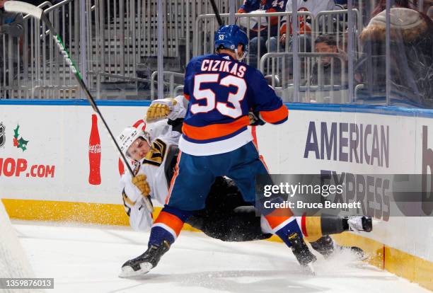 Casey Cizikas of the New York Islanders checks Brett Howden of the Vegas Golden Knights during the first period at the UBS Arena on December 19, 2021...