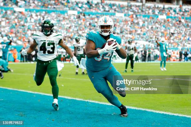 Christian Wilkins of the Miami Dolphins scores on a touchdown reception against the New York Jets in the fourth quarter at Hard Rock Stadium on...