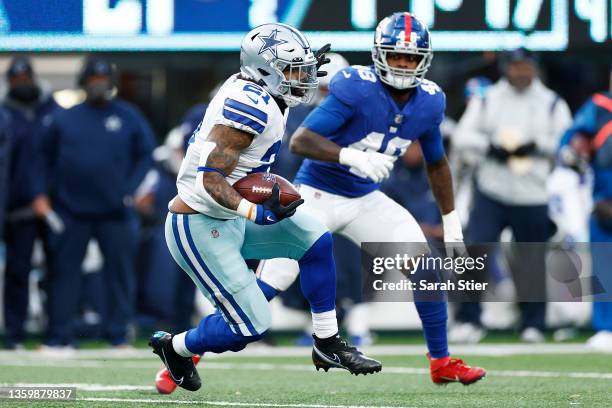 Ezekiel Elliott of the Dallas Cowboys runs the ball as Tae Crowder of the New York Giants looks to make the tackle during the third quarter at...