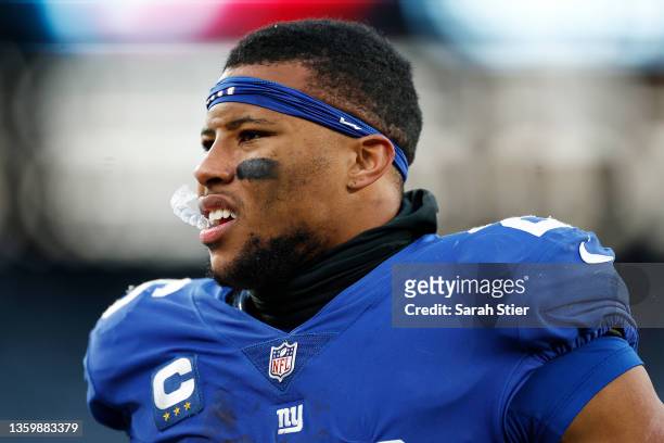 Saquon Barkley of the New York Giants walks off the field after being defeated by the Dallas Cowboys 21-6 at MetLife Stadium on December 19, 2021 in...