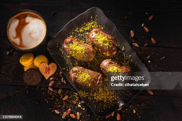 chocolate eclairs and coffee - choux pastry stock pictures, royalty-free photos & images
