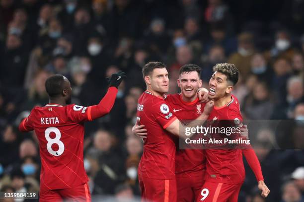 Andrew Roberton of Liverpool celebrates with team mates James Milner and Roberto Firminho after scoring his sides second goal during the Premier...