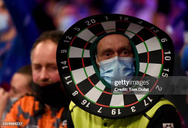 Dressed up spectator with a face mask looks on during Day Five of the 2021/22 PDC William Hill World Darts Championship at Alexandra Palace on...