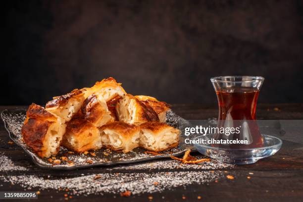 turkish pastry and tea black background - close up bread roll black backdrop horizontal stock pictures, royalty-free photos & images