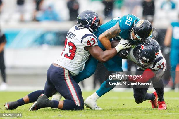 James O'Shaughnessy of the Jacksonville Jaguars is tackled by Neville Hewitt and Tavierre Thomas of the Houston Texans during the fourth quarter at...