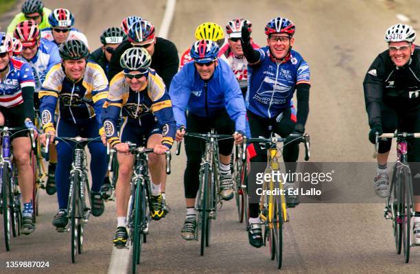 American cyclist Lance Armstrong waves as he participates, with unidentified others, in his annual Ride for the Roses, Texas, October 24, 2003. The...