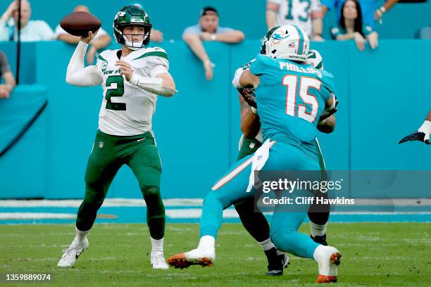 Zach Wilson of the New York Jets looks to make pass play against the Miami Dolphins in the second half at Hard Rock Stadium on December 19, 2021 in...