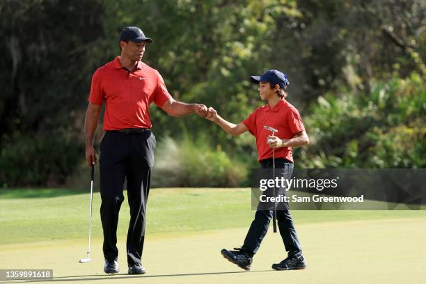 Tiger Woods and Charlie Woods celebrate a birdie on the 12th hole during the final round of the PNC Championship at the Ritz Carlton Golf Club Grande...