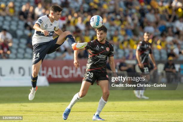 Harrison Steele of the Mariners contests the ball against Terry Antonis of the Wanderers during the A-League mens match between Central Coast...