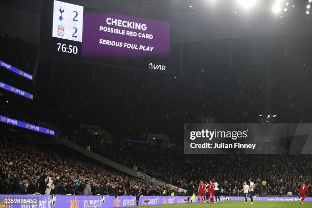 Referee Paul Tierney checks VAR after Andrew Robertson of Liverpool fouled Emerson Royal of Tottenham Hotspur which later leads to a red card during...