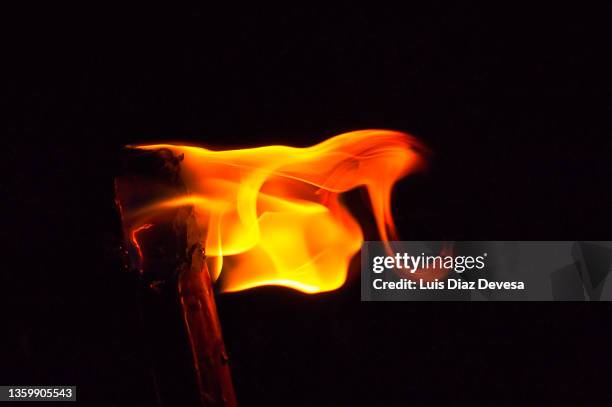 flaming torch at night - torch flame stock pictures, royalty-free photos & images