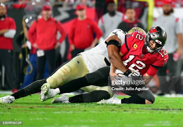Tom Brady of the Tampa Bay Buccaneers is sacked by Marcus Davenport of the New Orleans Saints during the 2nd quarter of the game at Raymond James...