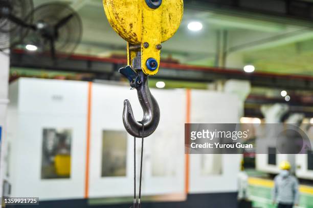 crane hook in the production workshop. - cable winch stock pictures, royalty-free photos & images
