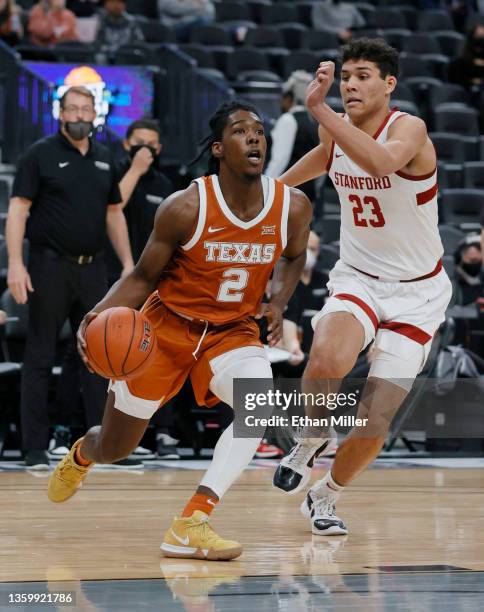 Marcus Carr of the Texas Longhorns drives against Brandon Angel of the Stanford Cardinal during the Pac-12 Coast-to-Coast Challenge at T-Mobile Arena...