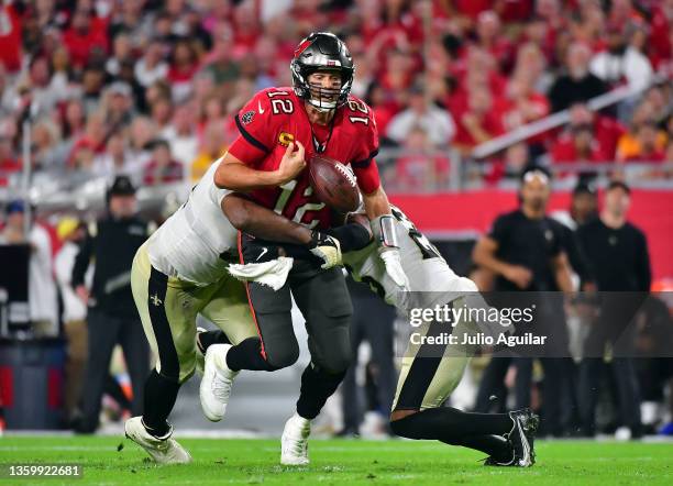 Tom Brady of the Tampa Bay Buccaneers fumbles the ball as he is hit by Cameron Jordan of the New Orleans Saints during the 4th quarter of the game at...