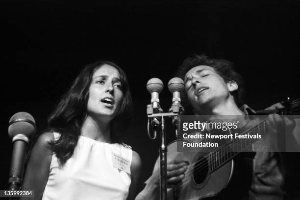 Folk singers Bob Dylan and Joan Baez perform at the Newport Folk Festival in July 1963 in Newport, Rhode Island.