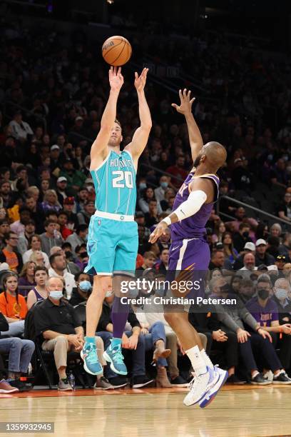 Gordon Hayward of the Charlotte Hornets shoots a three-point shot over Chris Paul of the Phoenix Suns during the first half of the NBA game at...