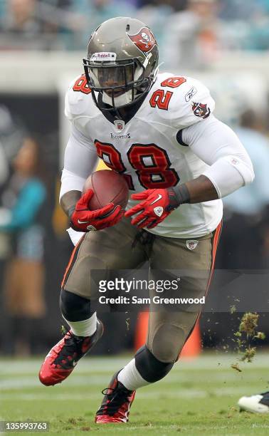Kregg Lumpkin of the Tampa Bay Buccaneers runs for yardage during the game against the Jacksonville Jaguars at EverBank Field on December 11, 2011 in...