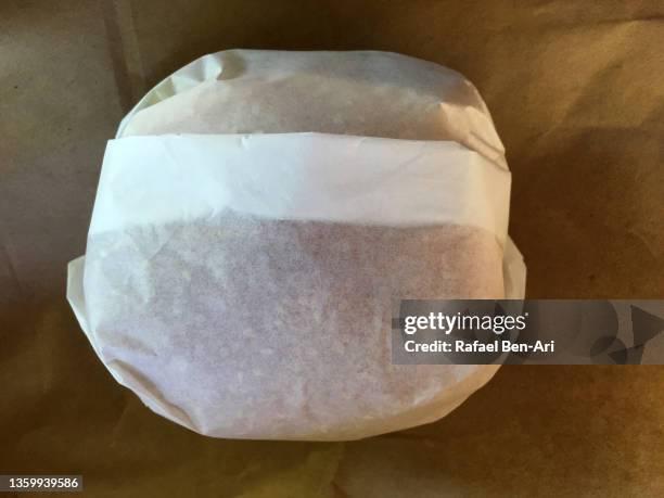 burger covered with wrapping paper - burger close up stock pictures, royalty-free photos & images