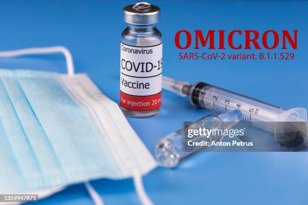 vaccine with syringe on blue background. coronavirus vaccine, coronavirus  covid-19 omicron variant - omicron photos et images de collection