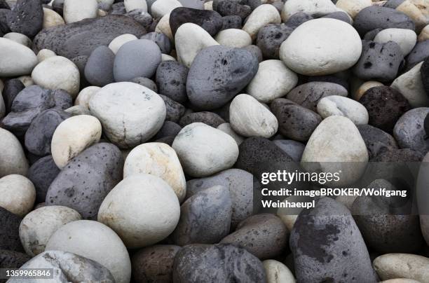 large round stones on the coast of rocha da relva, sao miguel island, azores, portugal - relva stock-fotos und bilder