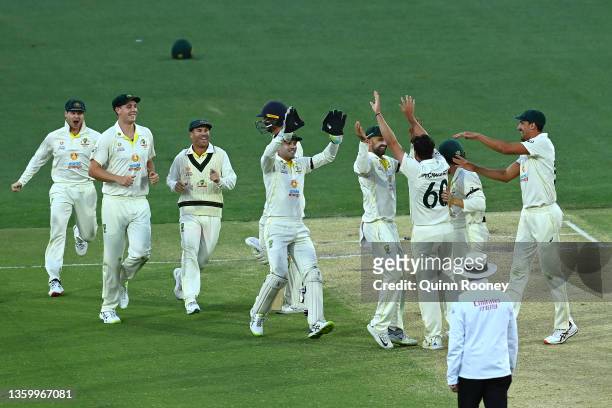 Jhye Richardson of Australia celebrates with team mates after taking the wicket of Jos Buttler of England for 26 runs during day five of the Second...