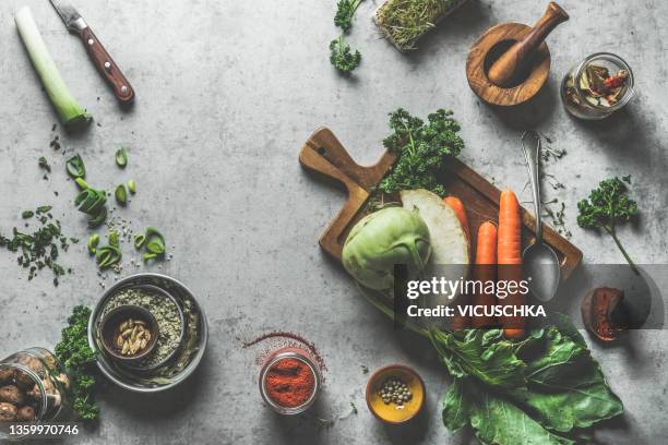 food background with seasonal vegetables and kitchen utensils on grey concrete table - wooden board　food stock pictures, royalty-free photos & images