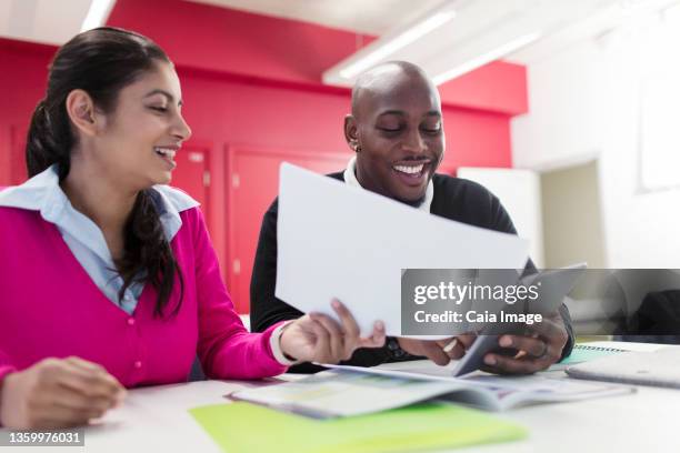 smiling community college students with paperwork and digital tablet - digital techniques ストックフォトと画像