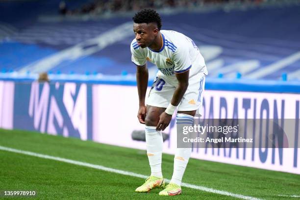 Vinicius Junior of Real Madrid adjusts his socks during the LaLiga Santander match between Real Madrid CF and Cadiz CF at Estadio Santiago Bernabeu...