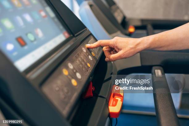 an unrecognizable person exercising on a treadmill in the gym - extreme dieting stock pictures, royalty-free photos & images